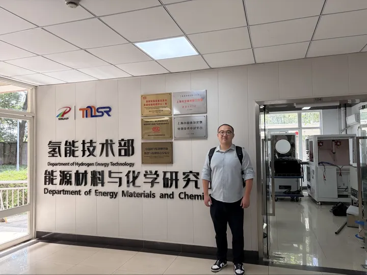Ding Jiang at the SINAP department wall in Shanghai